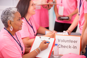 Volunteers check-in at a local Breast Cancer Awareness event