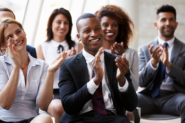 Audience Applauding Speaker At Business Conference